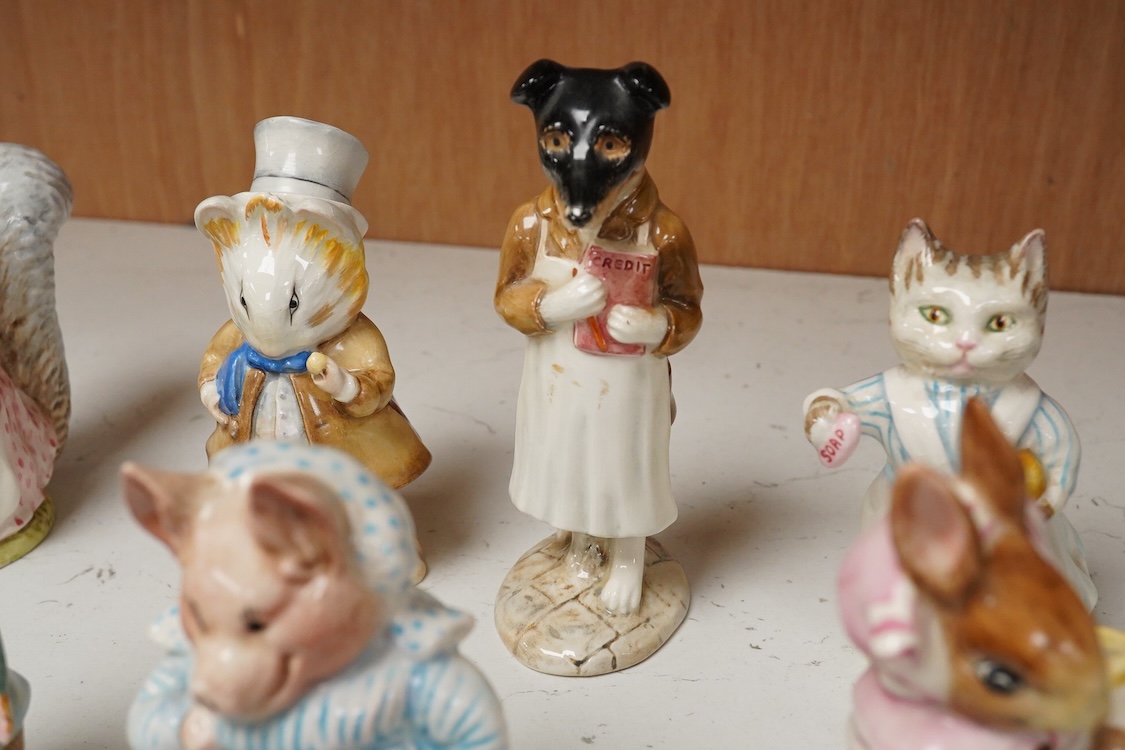 A collection of thirteen Beatrix Potter character figures, stamped with a gold stamp F Warne and Co Ltd, Beswick England, largest 12cm high